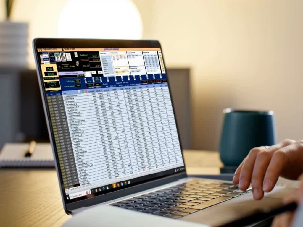 Speed E-Com Solution profit and settlement analysis dashboard on a laptop